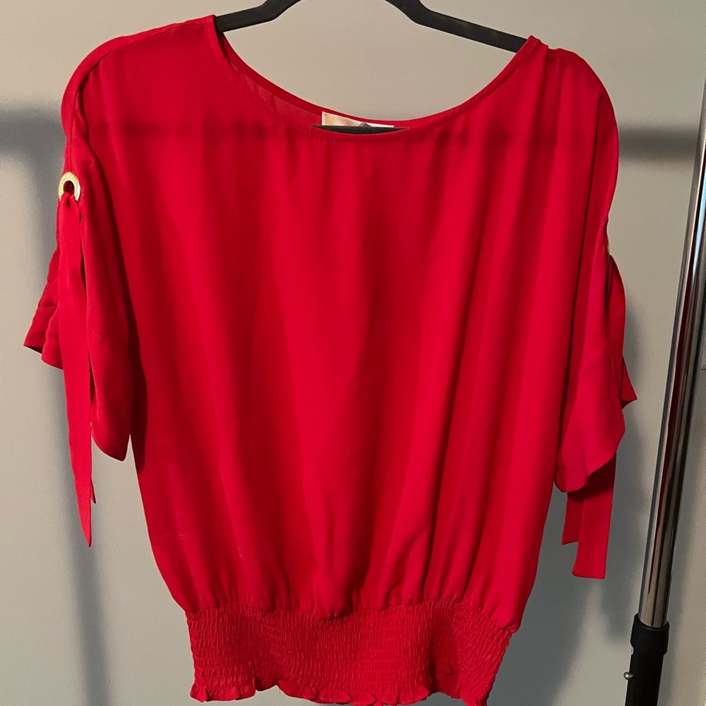 Fiery pink, top with embellished sleeve and fitted waist.